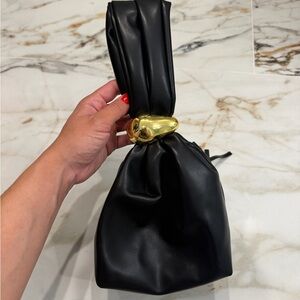 Black Leather Knot-Handle Wrist Bag with Gold Accent